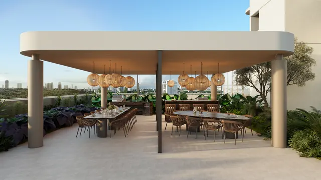 Espaço gourmet do Elevare, com bancada de churrasqueira e mesa comunitária
