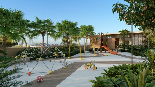 Play externo do Elevare, com brinquedos sobre piso emborrachado e sombra do paisagismo