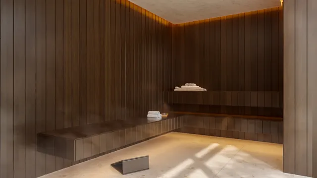 Sauna do Elevare, revestida em madeira clara, com banco corrido e luz indireta